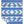 A beautiful blue and white Indigenous blanket shown flat against a white background with one corner folded over to reveal the reverse side.